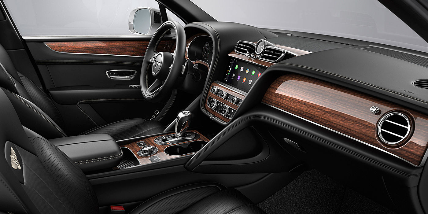 Bentley Bahrain Bentley Bentayga interior with a Crown Cut Walnut veneer, view from the passenger seat over looking the driver's seat.