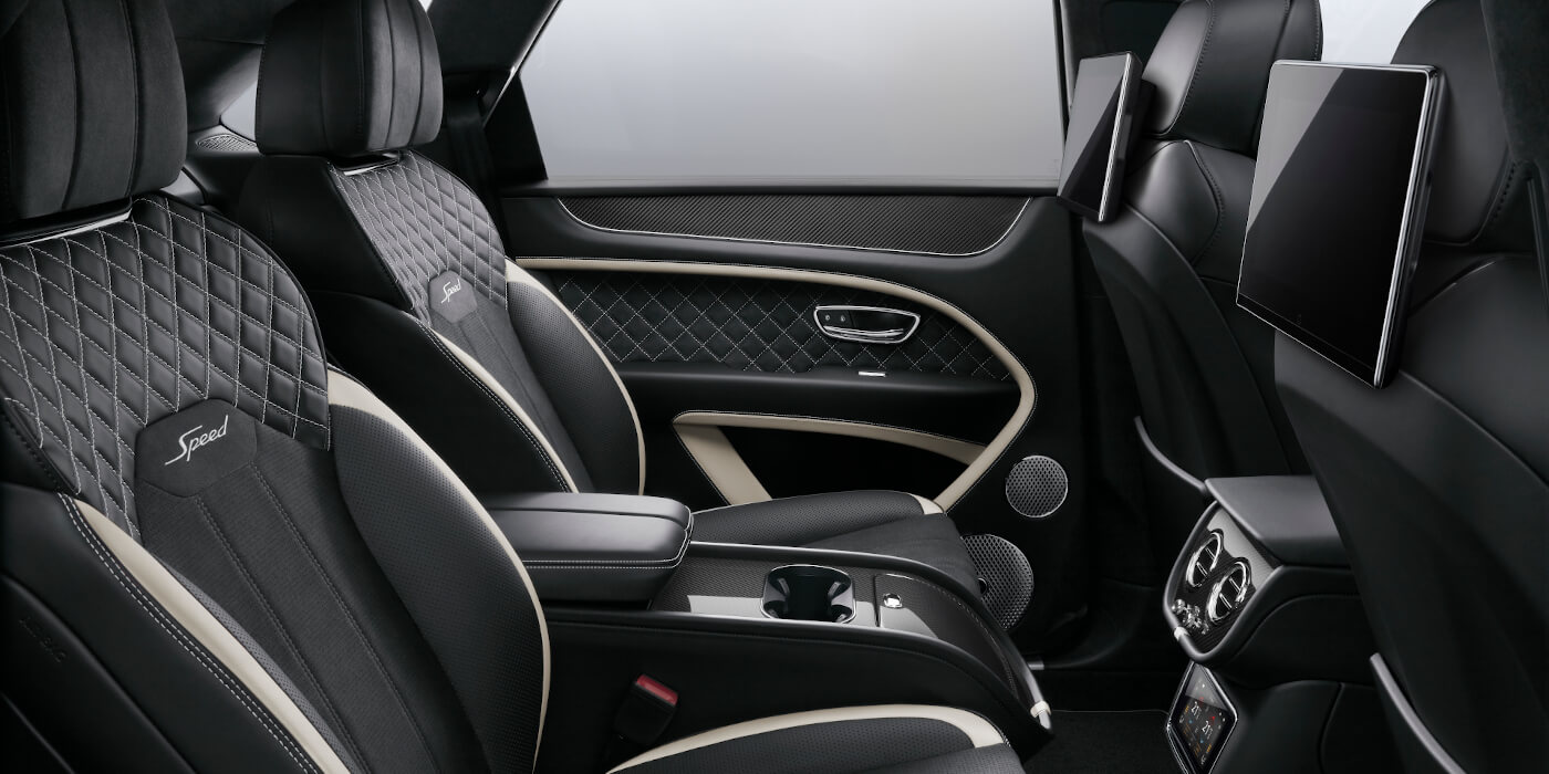 Bentley Bahrain Bentley Bentayga Speed SUV rear interior in Beluga black and Linen hide with carbon fibre veneer