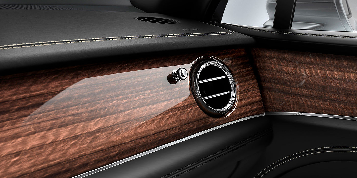 Bentley Bahrain Bentley Bentayga front interior Crown Cut Walnut veneer and chrome air vent.