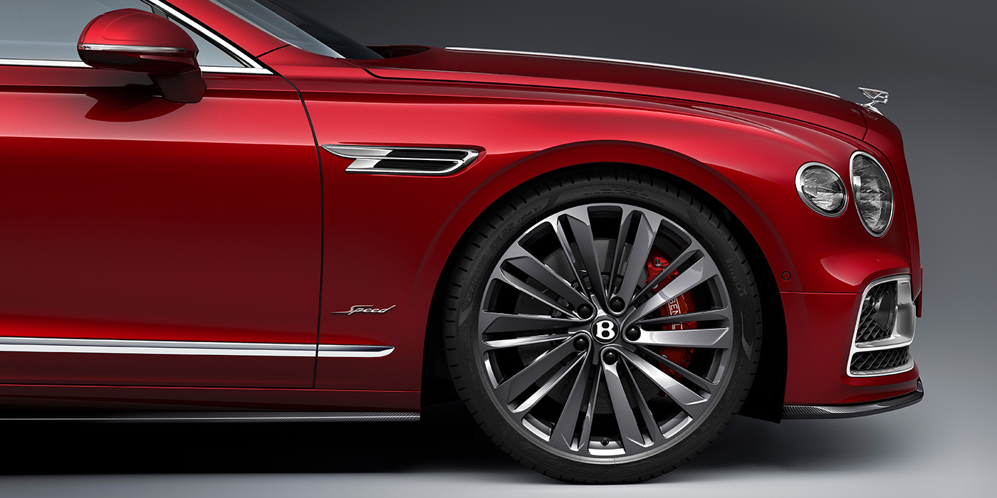 Bentley Bahrain Bentley Flying Spur Speed sedan front wheel in close up with Dragon Red II paint