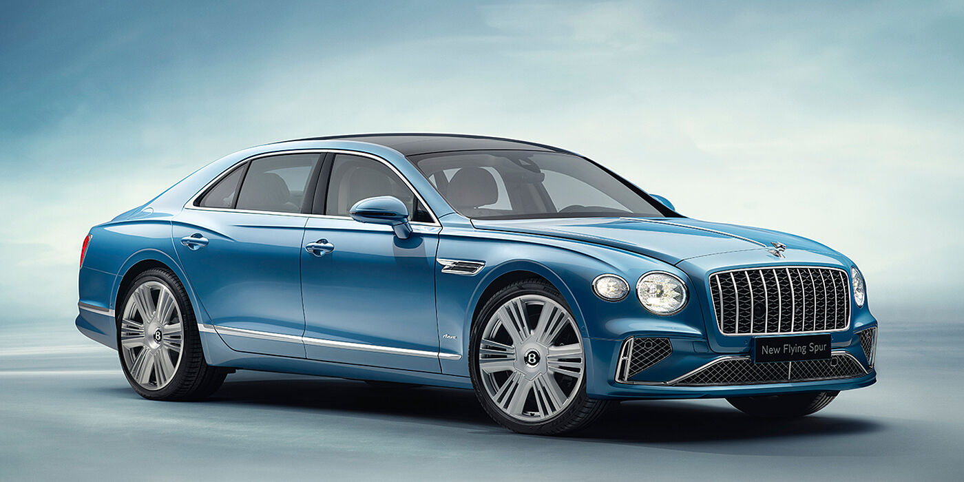 Bentley Bahrain New Bentley Flying Spur Azure sedan front view in Light windsor blue by Mulliner paint with 22 inch Azure wheels and chrome exterior details